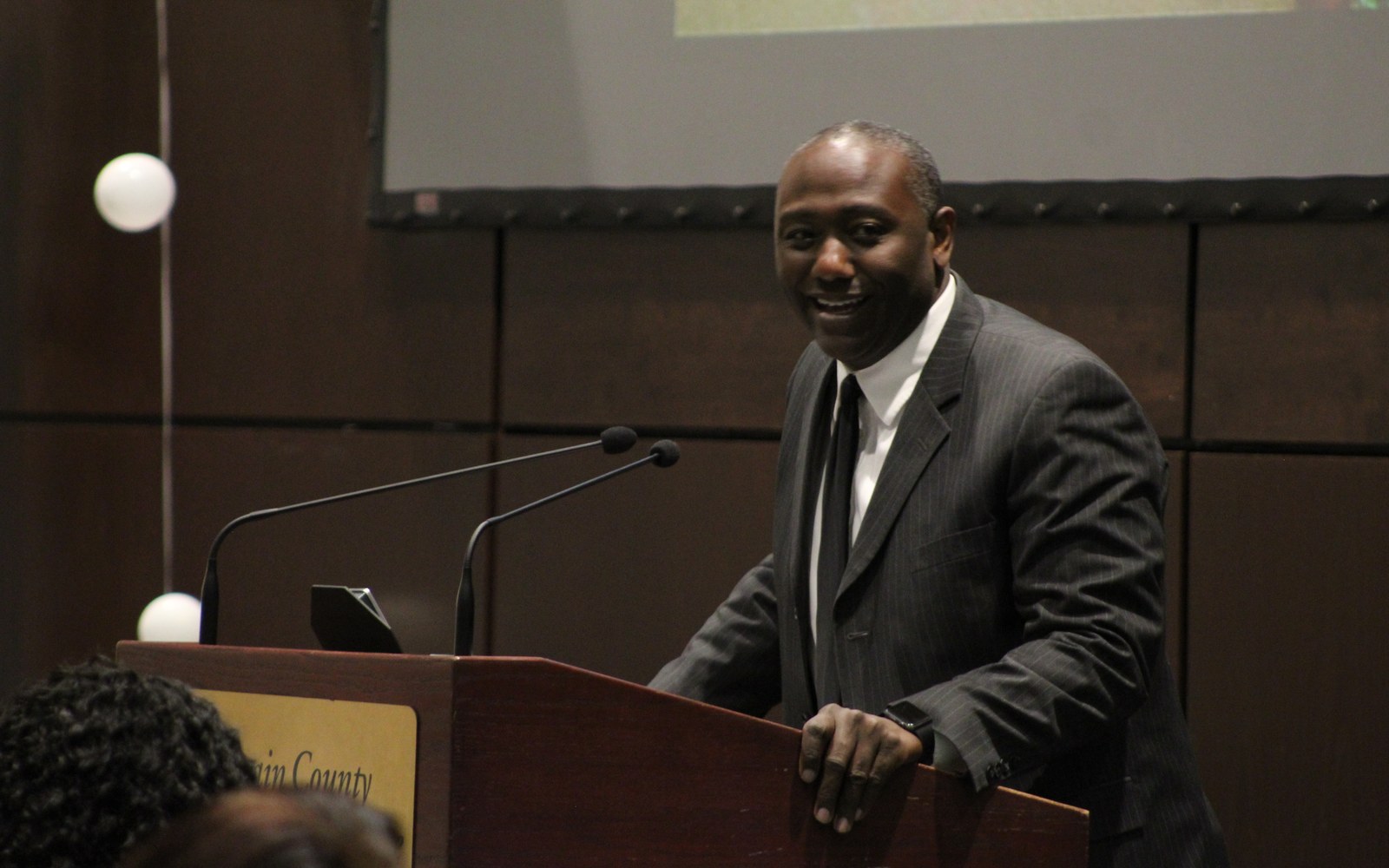 Dr. Mark Ballard delivering a keynote at the podium before a live audience