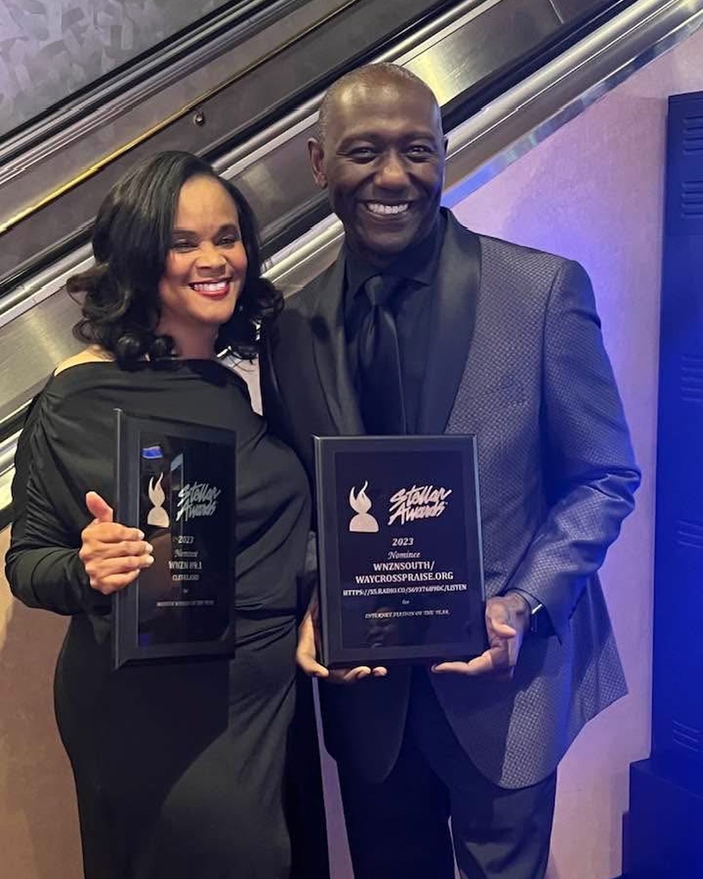 Dr. Mark Ballard holding 2023 Stellar Award nominee plaques for WNZN
